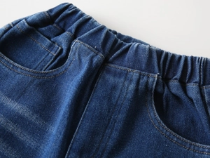 Detail of kids' dark blue denim jeans with comfortable elastic waistband and pockets