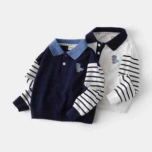 Detail of boys' polo sweatshirt featuring dinosaur embroidery and striped patchwork sleeves