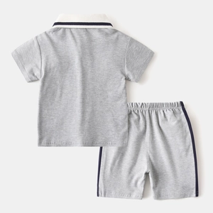 Macro detail of kids grey knit cotton polo set showing soft fabric texture and stitching