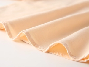 Macro d'un tissu en coton sergé abricot avec coutures d'ourlet de haute qualité