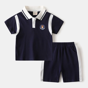 Detail of navy blue kids polo set showing cotton fabric and bear embroidery badge