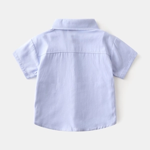 Back view of light blue boys short-sleeved cotton shirt with curved hem and yoke detail