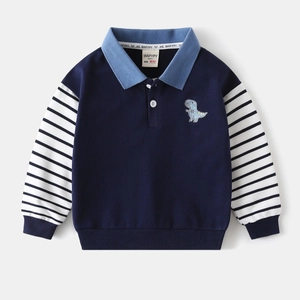 Close-up of boys' navy polo sweatshirt featuring dinosaur embroidery and striped sleeves