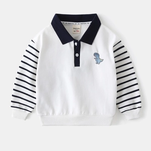 Detailed close-up of a boys' cream polo sweatshirt with striped sleeves and dinosaur patch