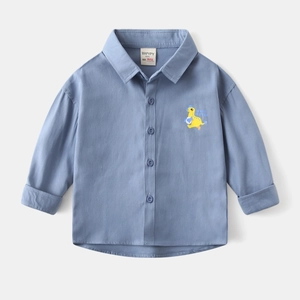 Detail of blue cotton toddler shirt with yellow dinosaur embroidery and classic collar