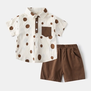 Detailed flat lay of boys beige polka dot shirt with brown shorts cotton summer set