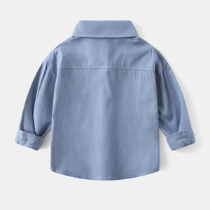 Detail view of the back yoke and stitching on this light blue long sleeve boy's shirt