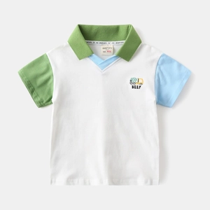Detail of color-block sleeves and cartoon truck print on boys' white cotton polo shirt