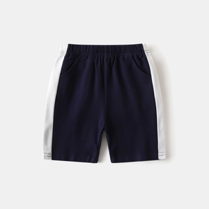 Detail of navy blue cotton sports shorts with side stripes and elastic waistband