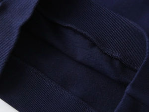 Close-up of boys' navy blue sweatshirt showing ribbed hem and soft fleece lining texture