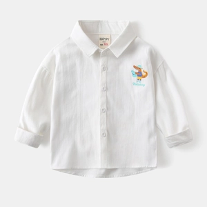 Close-up of white cotton shirt featuring a cartoon crocodile print and WAPYPY brand label