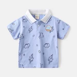 Detail of baby boy light blue polo shirt with dinosaur print and embroidered patch