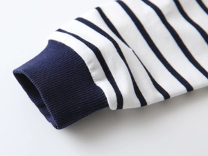 Close-up of navy blue and white striped shirt with ribbed elastic knit cuffs