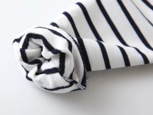 Macro detail of blue and white striped sweatshirt cuff showing soft terry cloth interior
