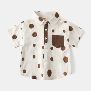 Close-up of cotton linen blend shirt with large brown polka dots and chest pocket