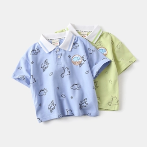 Detailed view of light blue and green cotton polo shirts with cute dinosaur print