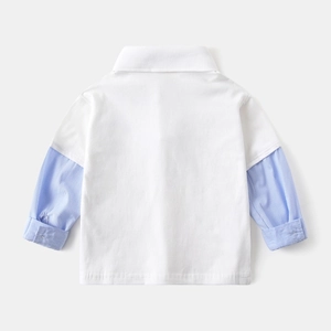 Detail of kids polo shirt with blue striped patchwork sleeves and button cuffs