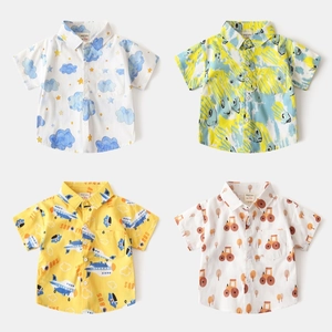 Collage of four boys short sleeve shirts featuring cartoon clouds, planes, and tractors prints