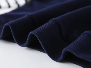 Macro view of ribbed navy knit cuffs and striped fabric stitching on boys' sweatshirt