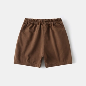 Detail of elastic waist and stitching on kids brown cotton shorts for summer