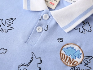 Close-up of polo shirt showing breathable mesh fabric, dinosaur embroidery and buttons
