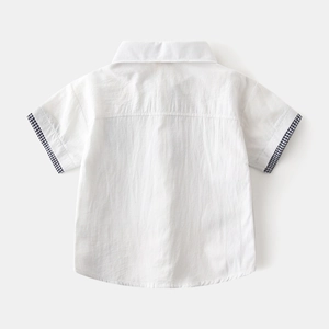 Close-up of white boys short sleeve shirt with navy plaid pattern cuffs detailing