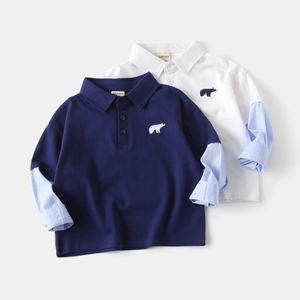 Detail of children's polo shirts featuring striped patchwork sleeves and bear embroidery
