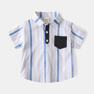 Detail of boys vertical stripe shirt showing chest pocket and cotton fabric texture