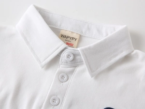 Detailed macro view of white cotton polo shirt collar with three buttons and brand label