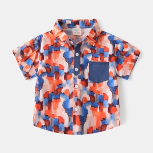 Close-up of boys short-sleeve shirt with artistic orange and blue watercolor prints