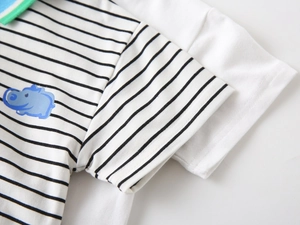 Detail view of cotton polo shirt with green trimmed collar and hippo print for boys