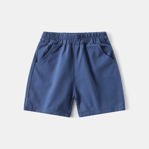 Detailed flat lay of blue cotton boys' shorts with an elastic waistband and side pockets