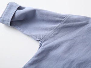 Close-up of the high-quality twill cotton fabric and precise stitching on the blue shirt cuff