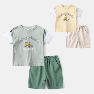 Detail of boys summer set showing cartoon dinosaur print and elastic cotton shorts