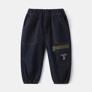 Close-up of boys cargo pants featuring contrast stitching and a cartoon cat embroidery detail