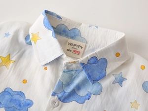 Close-up of boys' short sleeve shirt collar with watercolor clouds and star prints
