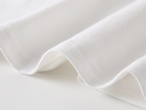 Detailed macro view of white polo shirt cuff featuring precise twin-needle stitching