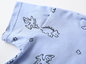 Close-up of light blue kids polo shirt with soft cotton texture and cartoon dinosaur print