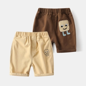 Detail of kids cotton shorts with elastic waistband and cartoon patch embroidery