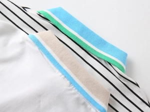 Detail of boys' polo shirt showing a colorful ribbed collar and striped knit fabric