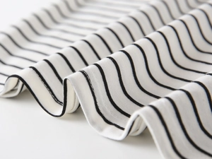 Macro shot of high-quality black and white striped cotton knit fabric with fine ribbed texture