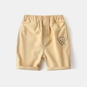 Detail of kids' khaki shorts featuring elastic waistband and small cartoon face embroidery