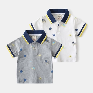 Detailed view of two boys' polo shirts featuring a cosmic astronaut print and striped collars