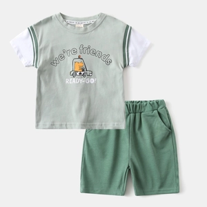 Detail view of cotton boy's summer set with cartoon dinosaur print and elastic waistband