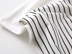 Detail of high-quality knit cotton fabric showing black and white stripes and stitching