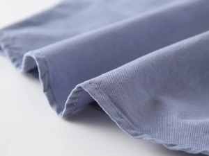 Close-up of blue-purple twill fabric with professional double-needle stitching detail