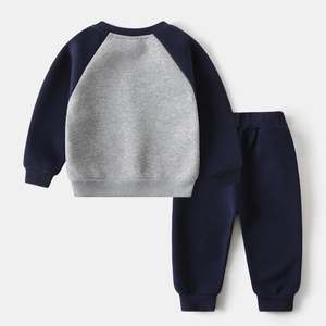 Flat lay of boys' grey and navy blue sweatshirt set with ribbed cuffs and raglan sleeves
