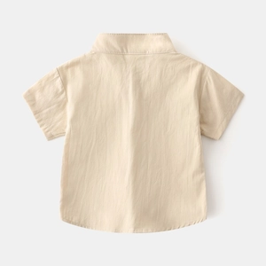 Detail view of the back of a beige cotton short-sleeved shirt with breathable texture