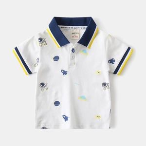 Close-up of boys' white polo shirt with navy contrast collar and space theme astronaut prints