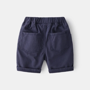 Detail view of boys' navy blue cotton shorts with elastic waist and back pockets